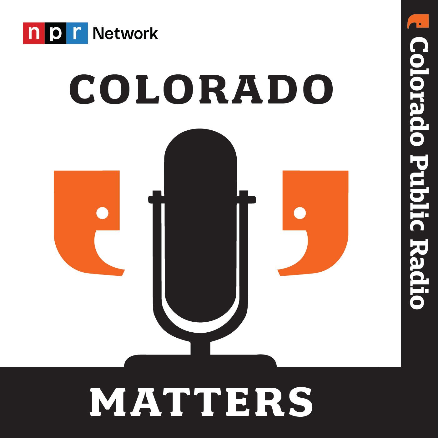 Two quote marks talking into a center microphone.